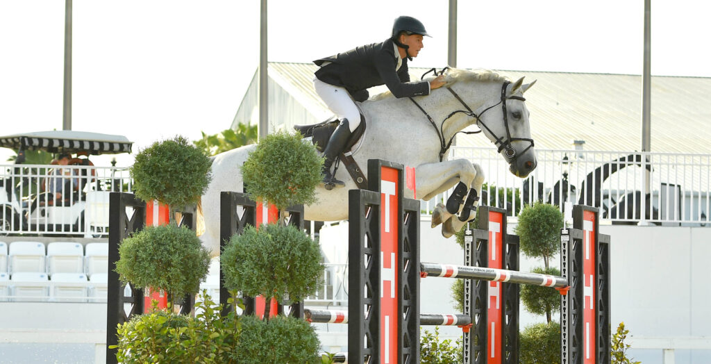 Equestrian Sharn Wordley and horse jumping at World Equestrian Center