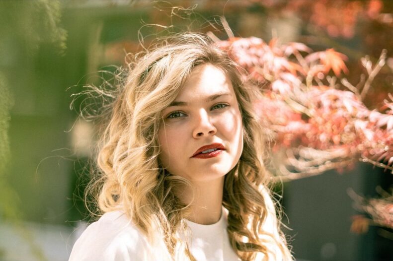 A woman with wavy blonde hair poses outdoors; text above and below advertises Allison Asarch performing at Yellow Pony Pub & Garden on Friday, November 8th, 6–9:30 PM ET.