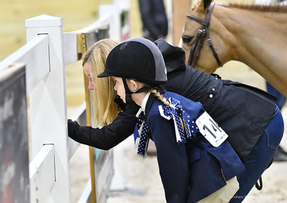 wilmington equestrian spectators child and adult looking through fence with horse