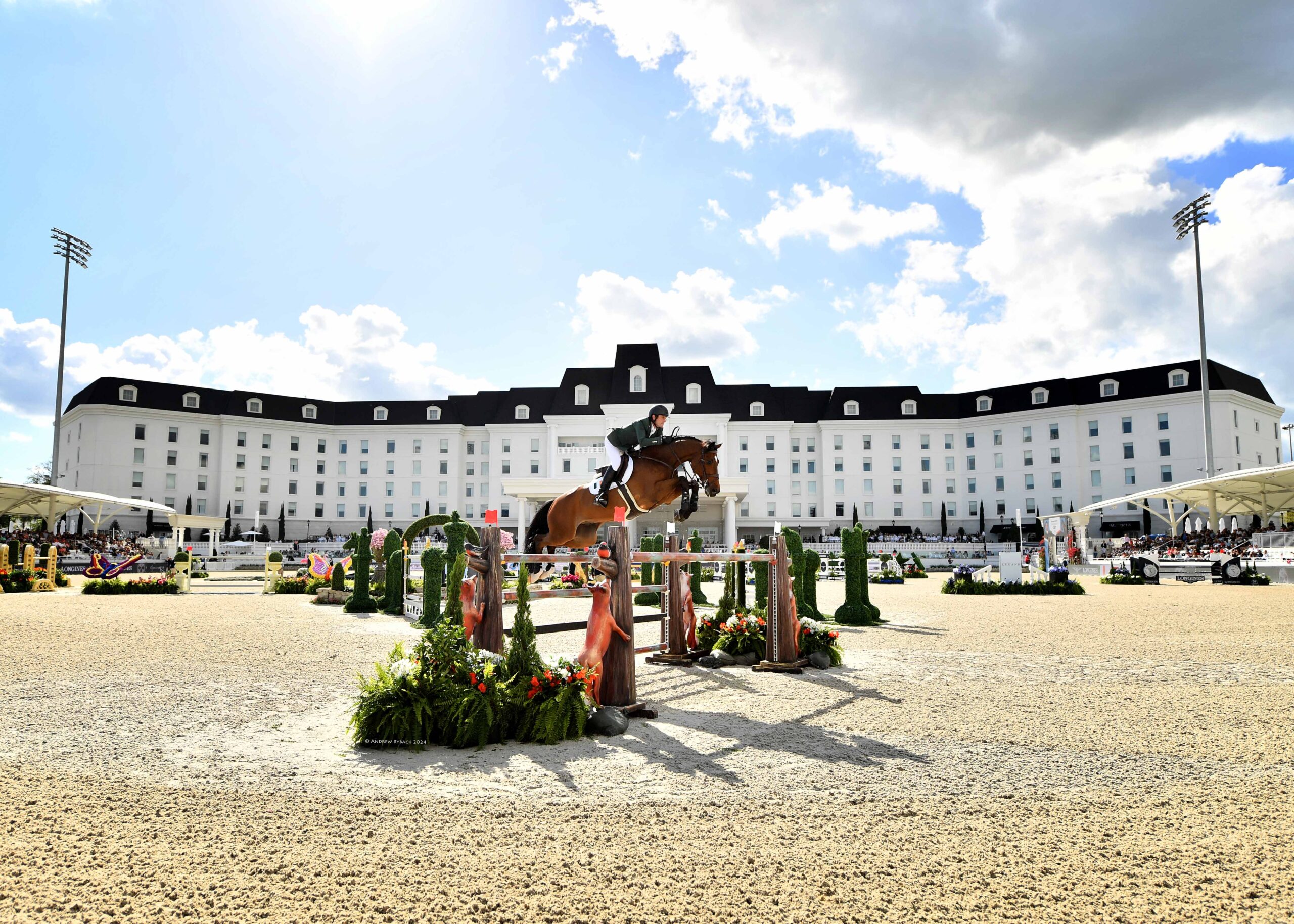Exhibitor competing in a jumper equestrian event at the WEC grand arena.
