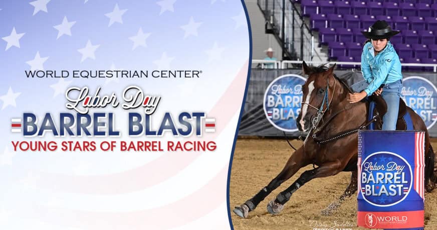 A rider in a blue shirt and black hat rounds a barrel on a horse at the Labor Day Barrel Blast event, hosted by the World Equestrian Center.