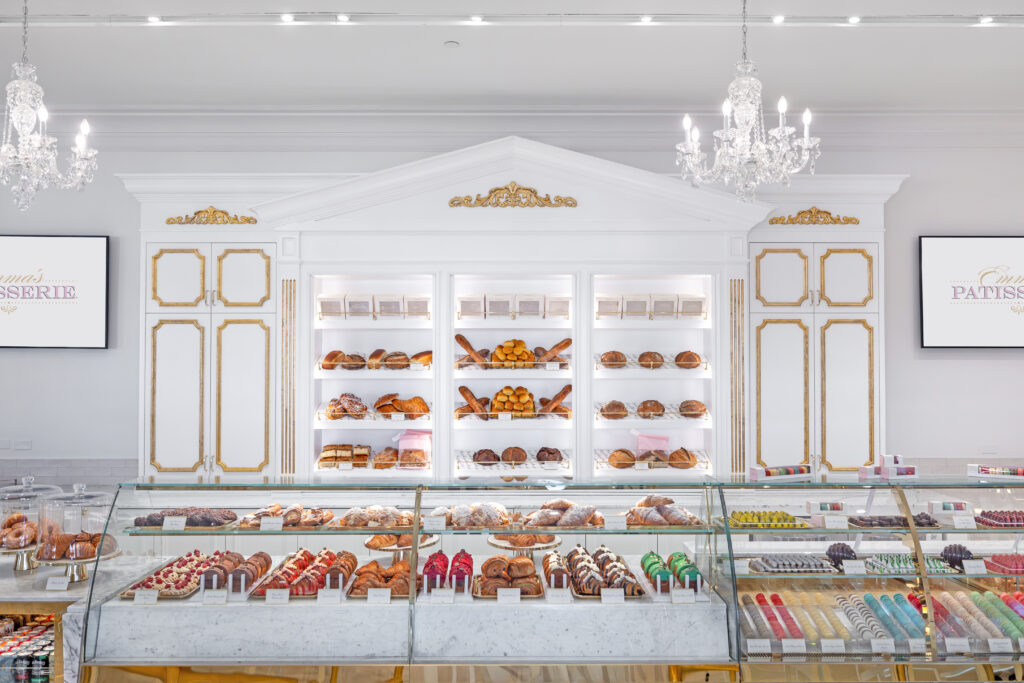 Display cases at Emma’s Patisserie at The Equestrian Manor with pastries, breads, chocolates and colorful macarons.
