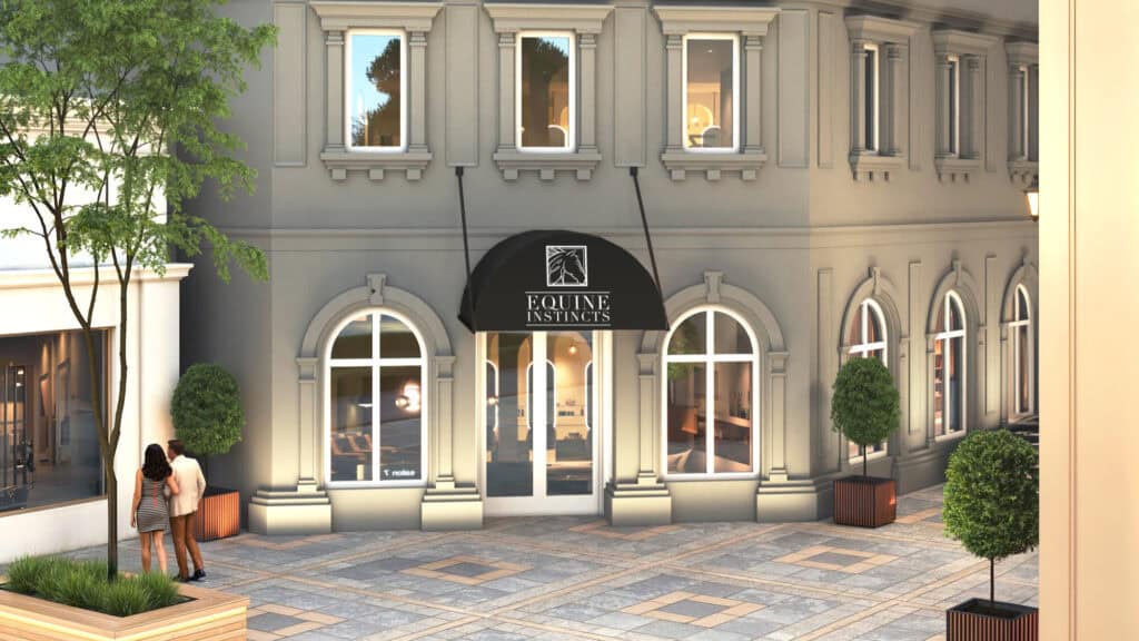 A storefront with arched windows and a black awning displaying “Equine Instincts”; two people stand outside on a paved walkway with trees and potted plants nearby.