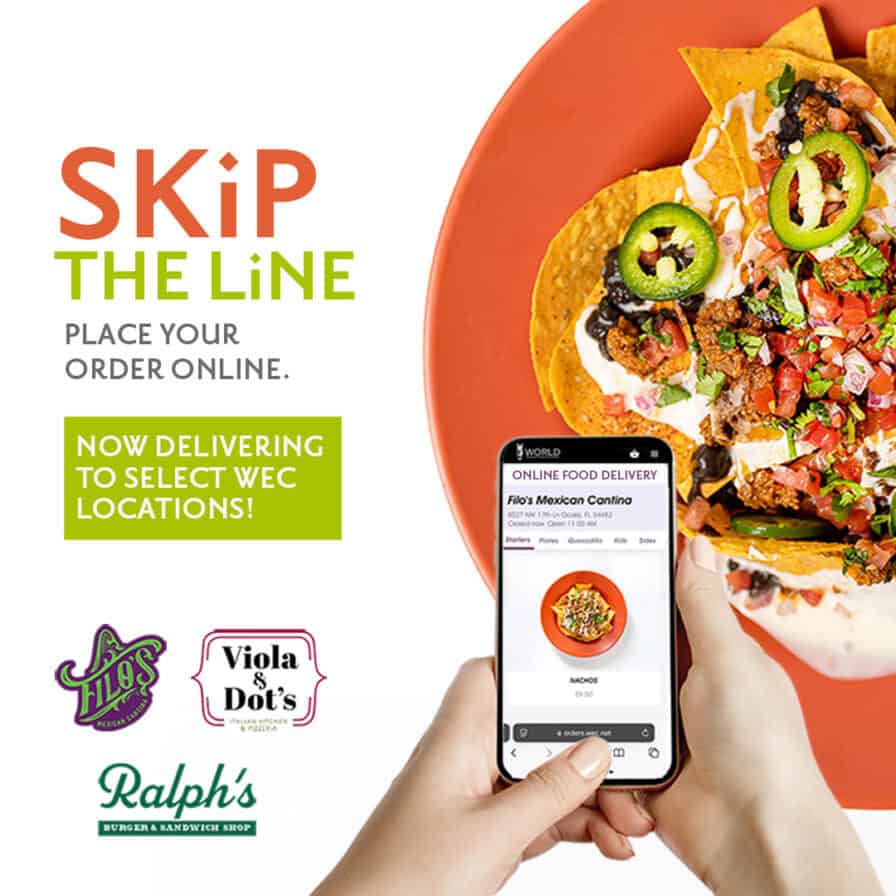A hand holds a smartphone showing an online food order for nachos, with a plate of loaded nachos in the background and text promoting food delivery service.