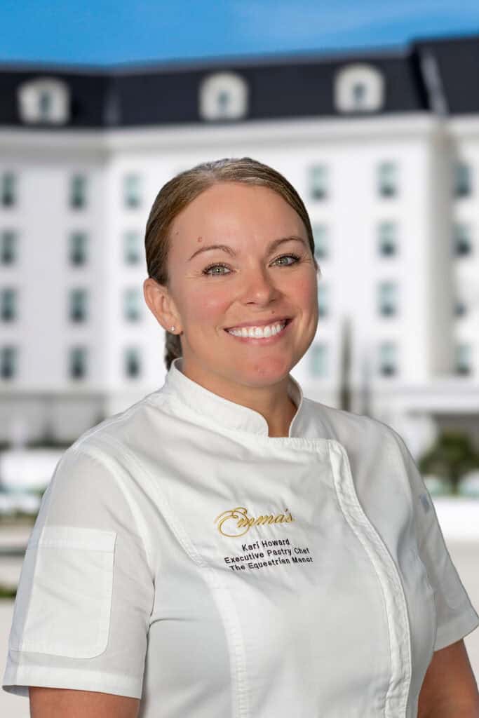 A woman wearing a white chef’s jacket with 