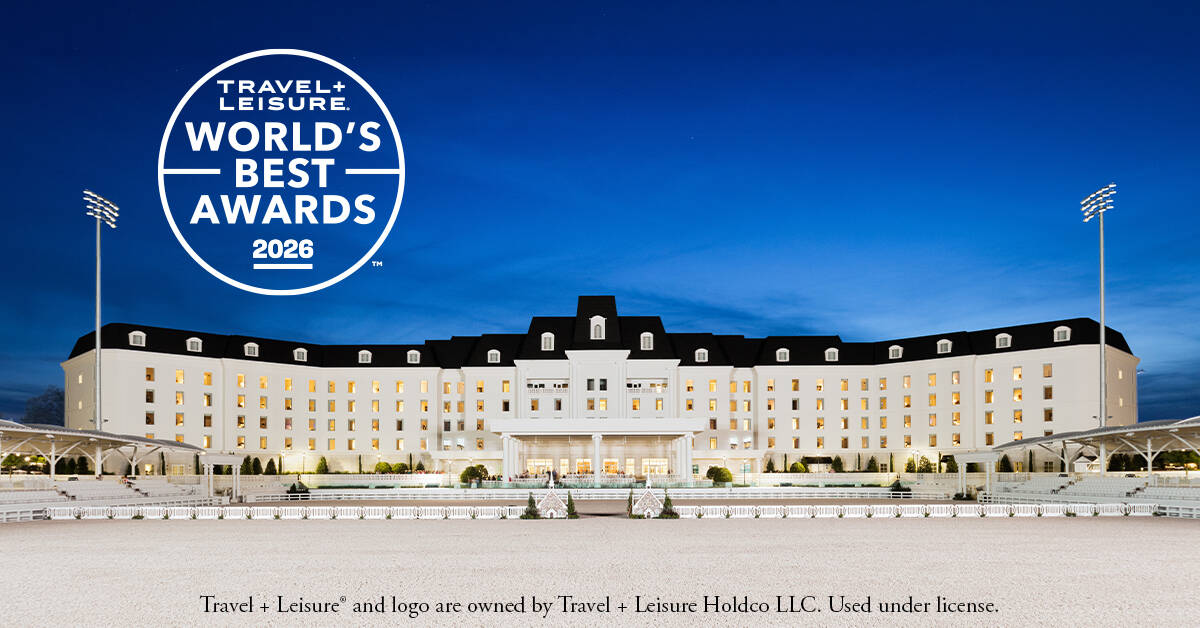 A large, elegant white hotel with multiple windows and black roof stands under a clear sky, with the Travel + Leisure World's Best Awards 2026 logo displayed.