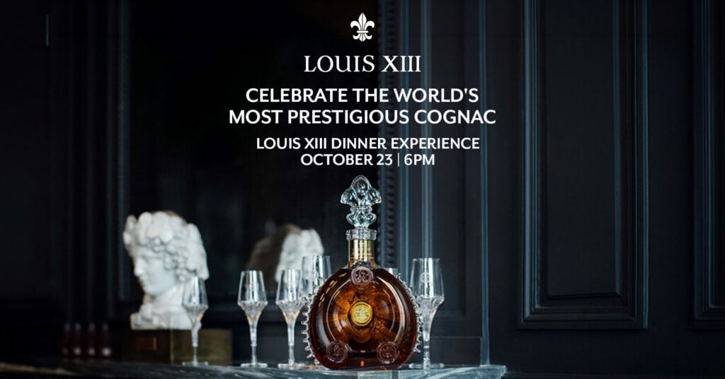 A bottle of Louis XIII cognac with four glasses is displayed on a table; event details for a Louis XIII Dinner Experience are written above.