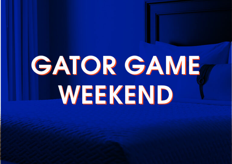 A neatly made bed in a hotel room with the words “Gator Game Weekend” overlaid in bold white text.
