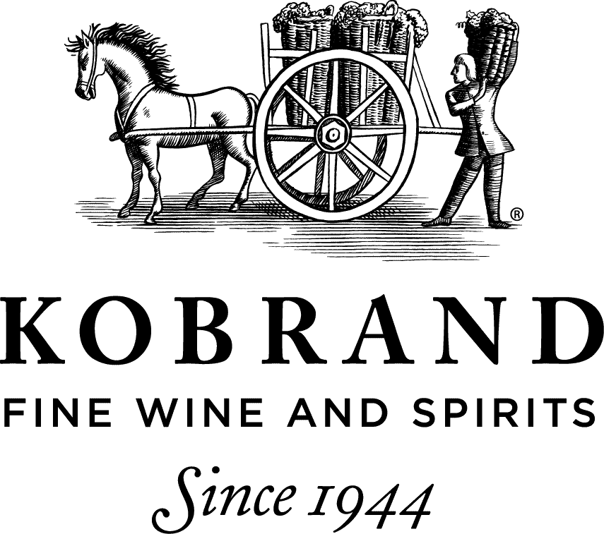 Drawing of a horse pulling a cart filled with barrels and a person carrying a basket, above the words “Kobrand Fine Wine and Spirits Since 1944.”.